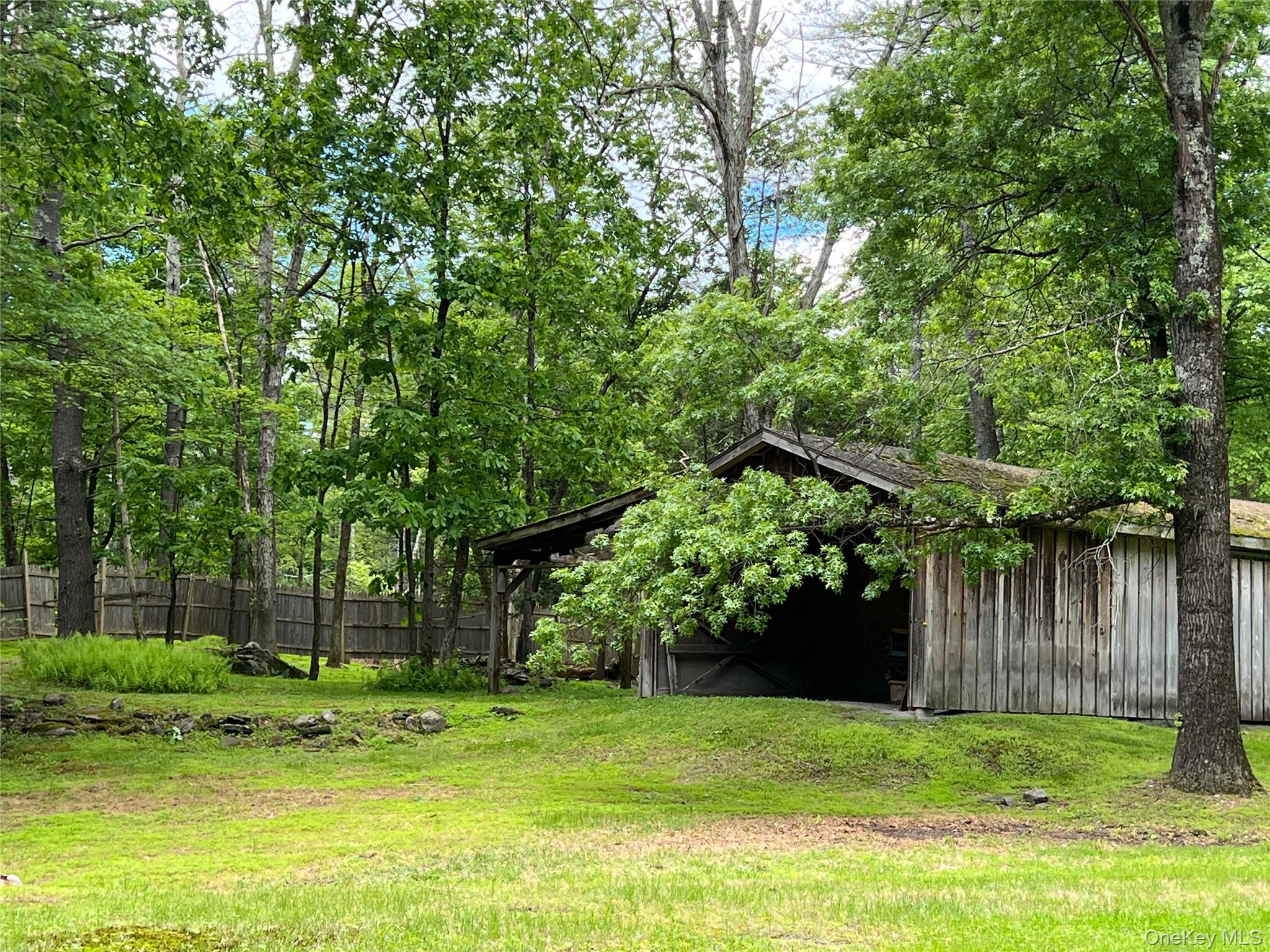 404 John Joy Road Saugerties, NY 12477 - Photo 27 of 50 a backyard of a house with plants and large trees