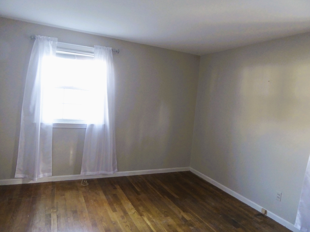 12 Gordon Drive Holyoke, MA 01040 - Photo 17 of 33 a view of an empty room with wooden floor and a window
