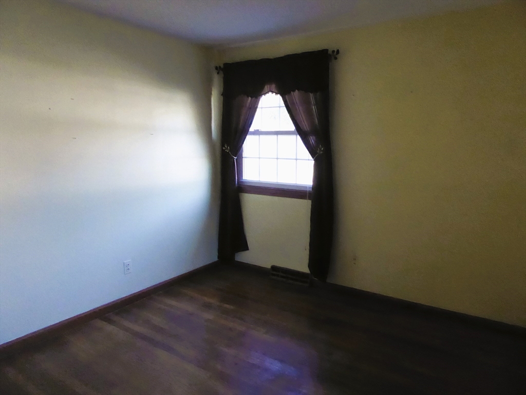 12 Gordon Drive Holyoke, MA 01040 - Photo 21 of 33 an empty room with wooden floor and windows