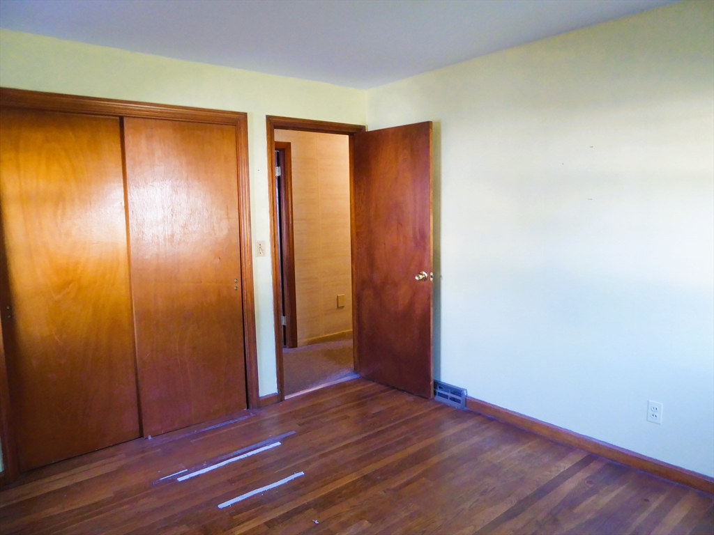 12 Gordon Drive Holyoke, MA 01040 - Photo 22 of 33 an empty room with wooden floor and closet area