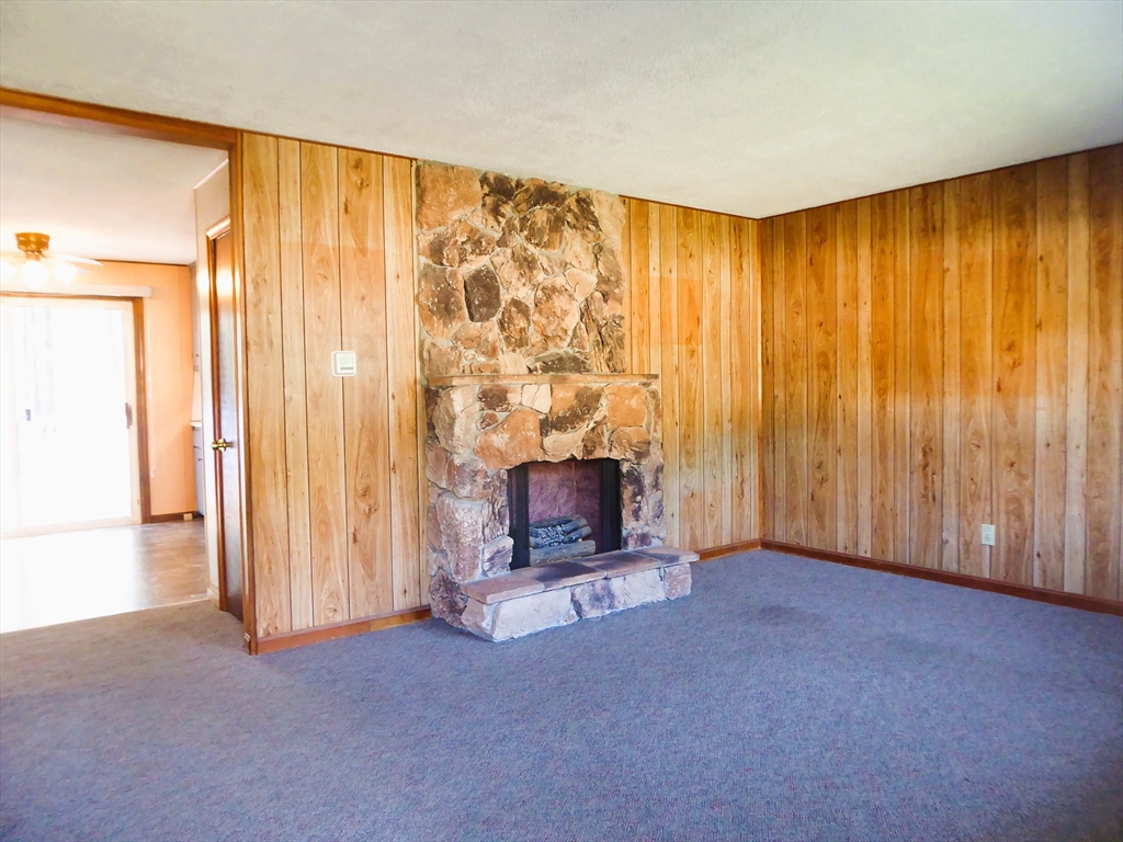 12 Gordon Drive Holyoke, MA 01040 - Photo 8 of 33 an empty room with a fireplace and window