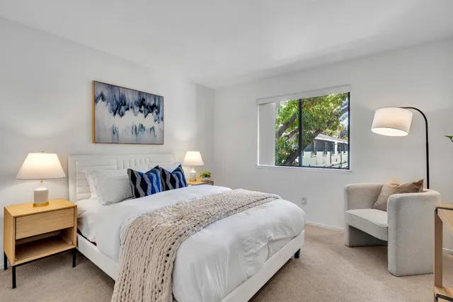 a bedroom with a bed wooden floor and a chandelier