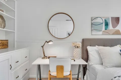 a bathroom with a granite countertop sink a toilet and shower