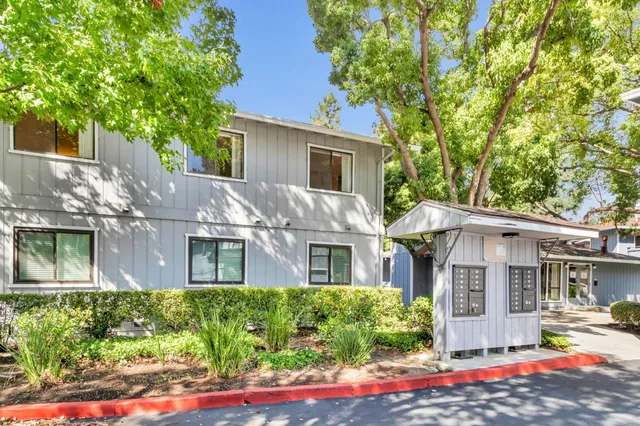 a front view of a house with a yard outdoor seating and garage