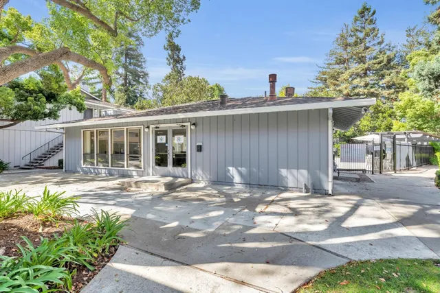a balcony with wooden floor and outdoor seating