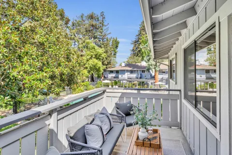 a swimming pool view with a seating space and a garden view
