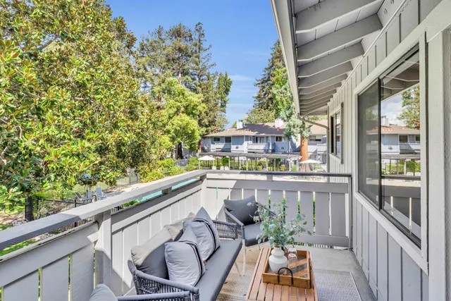 a swimming pool view with a seating space and a garden view