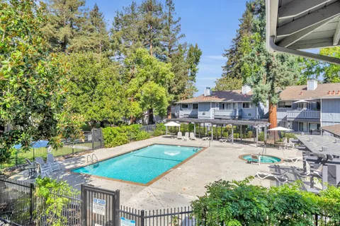 a front view of a house with swimming pool and porch