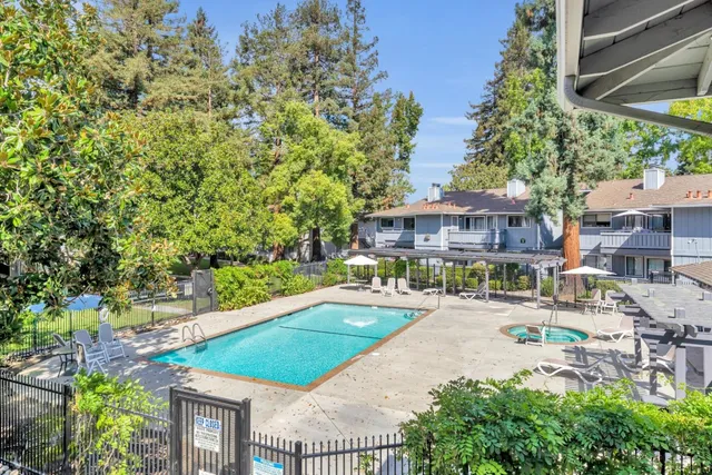 a front view of a house with swimming pool and porch