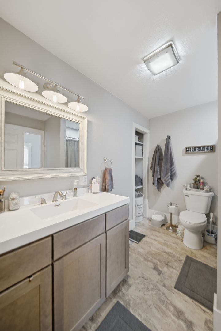 624 Palmyra Street Dixon, IL 61021 - Photo 22 of 29 a spacious bathroom with a double vanity sink and a mirror