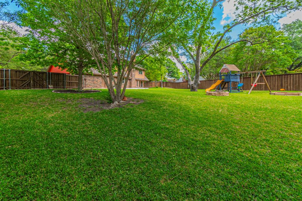 127 Nicklaus Nook Lancaster, TX 75146 - Photo 31 of 37 Fenced backyard featuring a playground