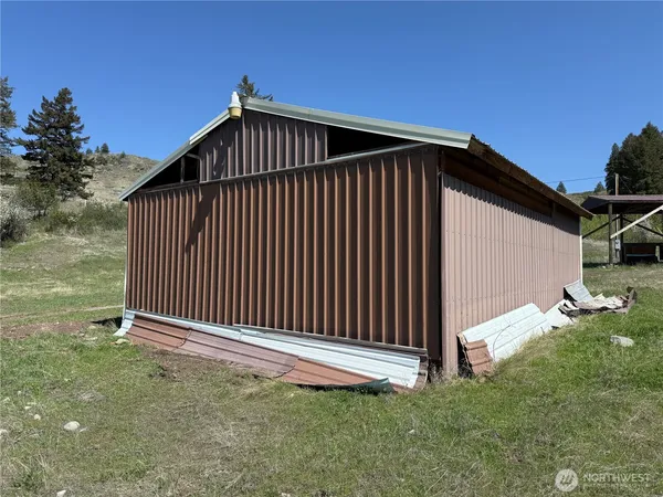 a view of a backyard with wooden fence