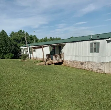 a view of backyard with seating area and green space