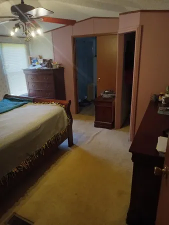 a bedroom with bed and mirror