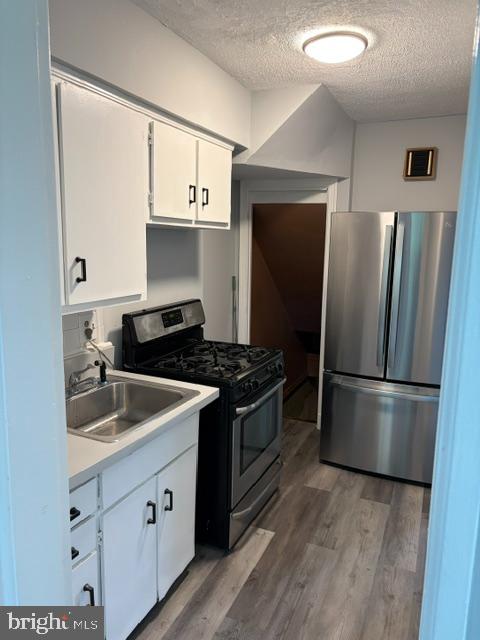 3024 M Street Southeast Washington, DC 20019 - Photo 5 of 8 a kitchen with stainless steel appliances granite countertop a sink stove and refrigerator