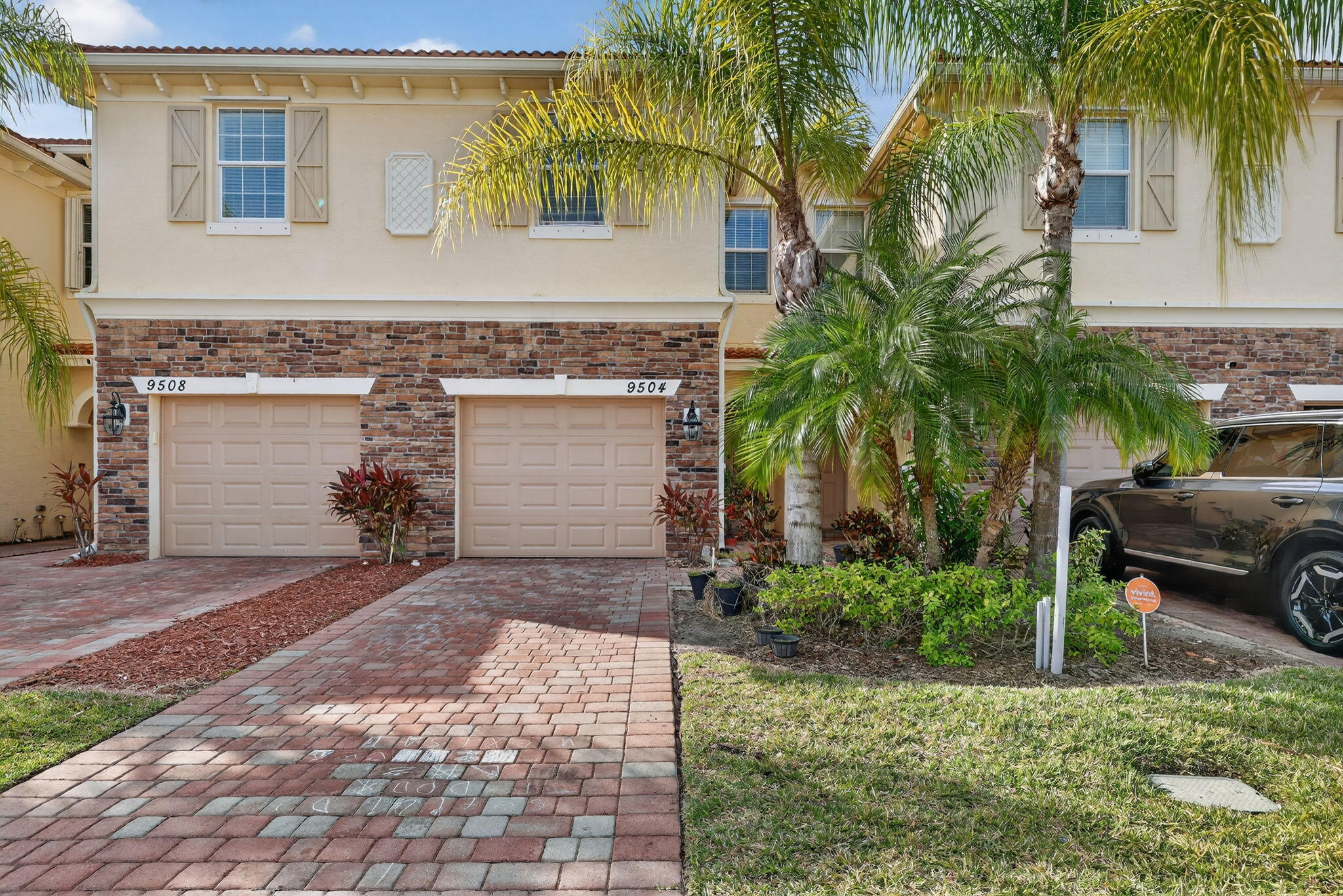 a couple of palm trees in front of house