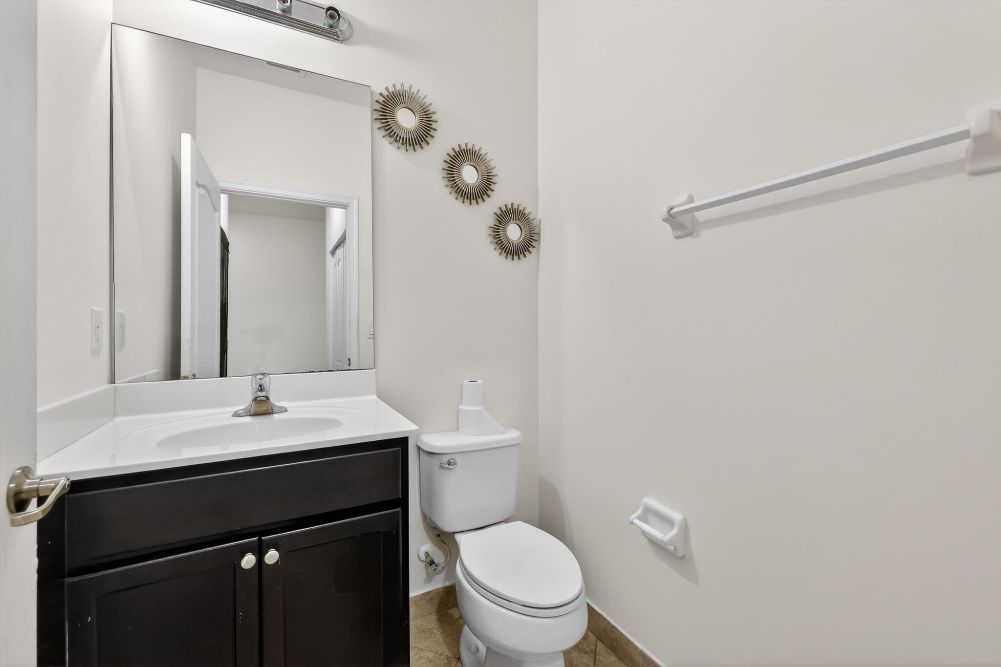 9504 Southwest Otter Lane Stuart, FL 34997 - Photo 12 of 36 a bathroom with a granite countertop sink toilet a mirror and shower