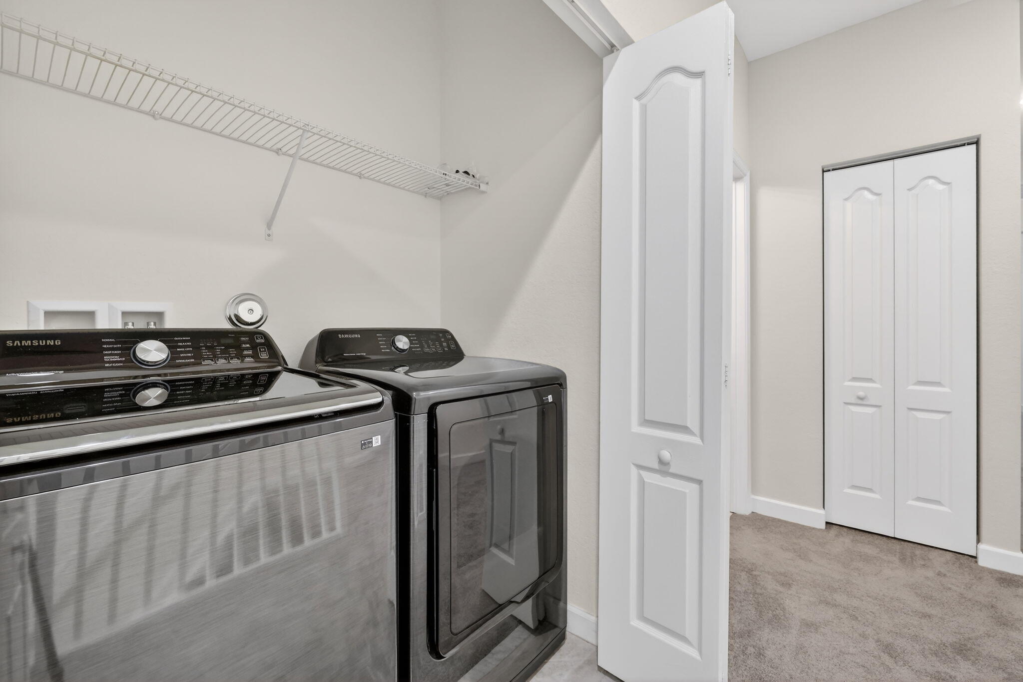 9504 Southwest Otter Lane Stuart, FL 34997 - Photo 16 of 36 a view of a utility room with racks on the wall