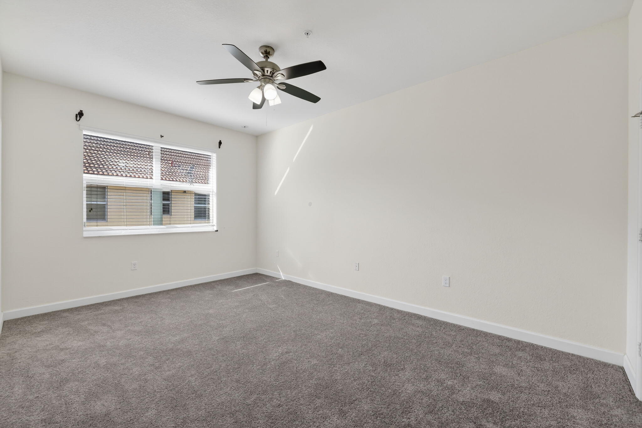 9504 Southwest Otter Lane Stuart, FL 34997 - Photo 17 of 36 a view of an empty room with a window