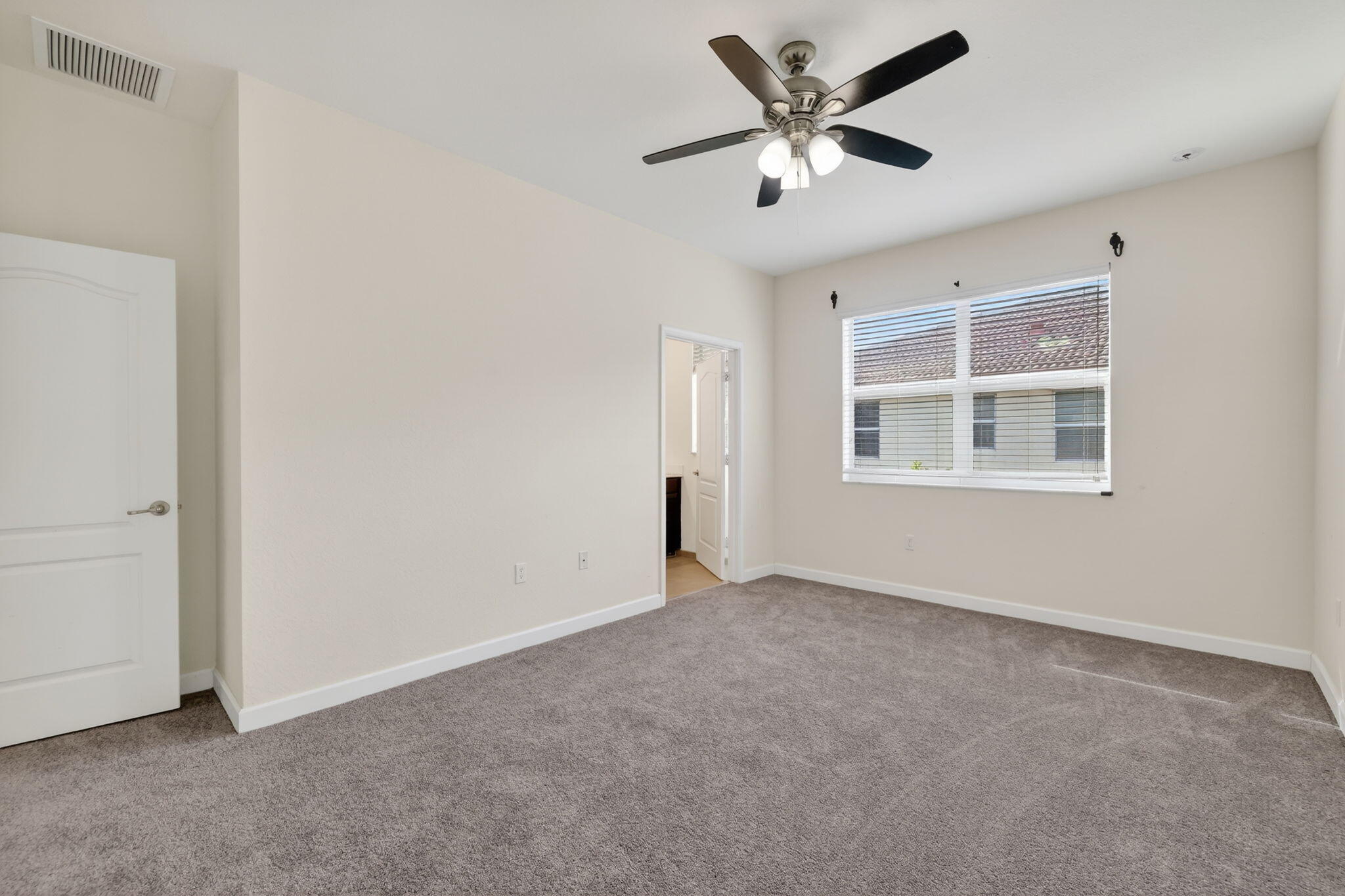 9504 Southwest Otter Lane Stuart, FL 34997 - Photo 18 of 36 an empty room with fan and windows