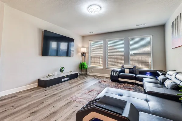 a living room with furniture kitchen view and a couch