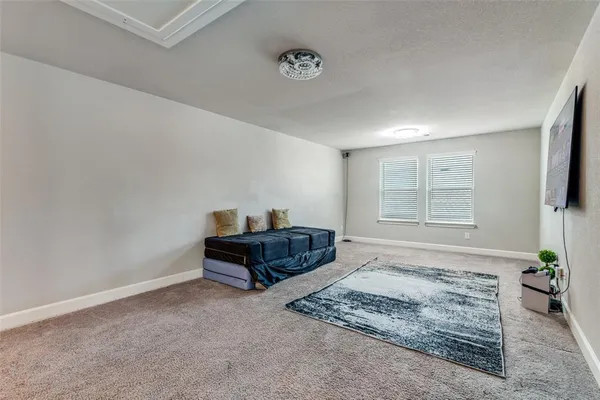 a bedroom with a bed and a potted plant
