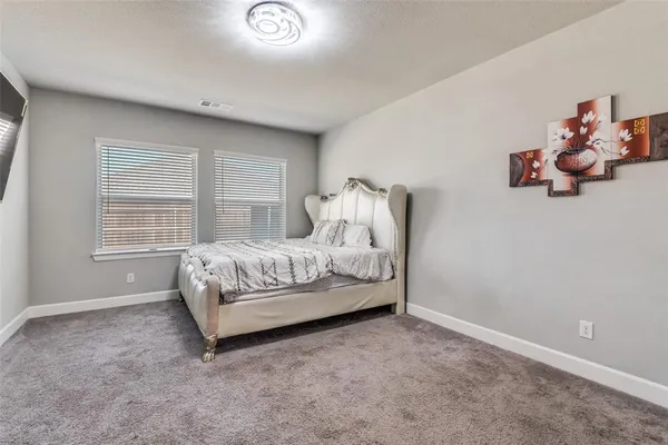 a living room with furniture a large window and wooden floors