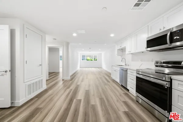 a view of kitchen with sink and stainless steel appliances