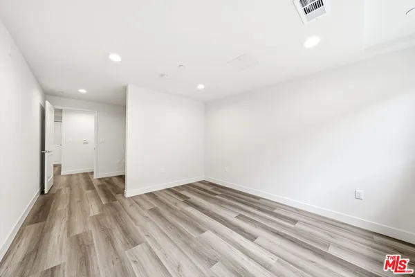 a view of wooden floor and entryway in a room