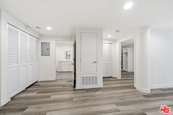 a view of empty room with wooden floor