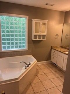 203 Indian Trail Road Seneca, SC 29672 - Photo 12 of 14 Tiled flooring, a deep soaking tub, and a vanity highlight this spacious bathroom.