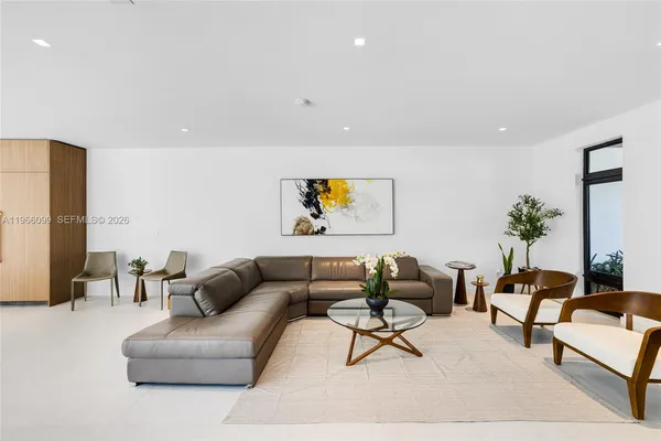 a living room with furniture and a potted plant