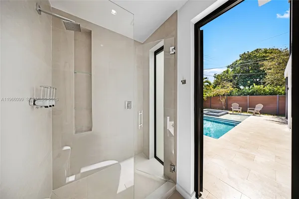 a living room with furniture and a book shelf