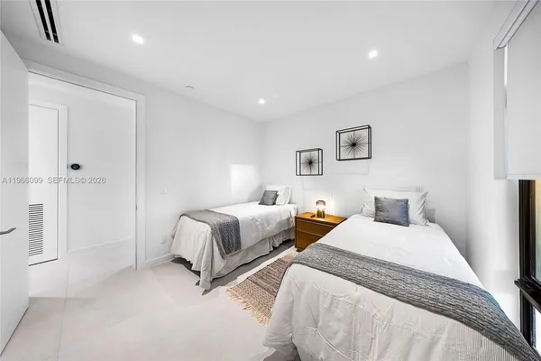 a living room with furniture and floor to ceiling window