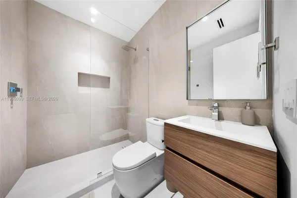 a view of a room with furniture and window