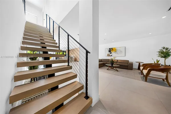 a view of a porch with furniture and floor to ceiling window