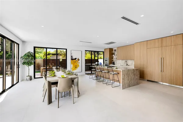 a kitchen with a table chairs and a dining table