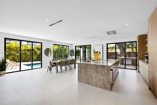 a living room with furniture and large windows