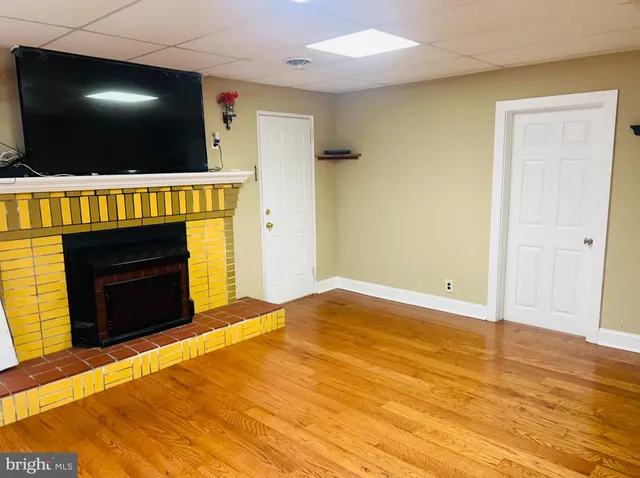 a view of empty room with a flat screen tv and a fireplace