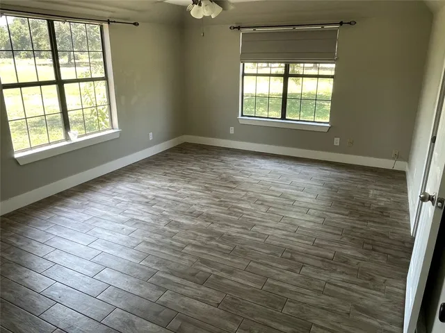 a bedroom with bed and a window