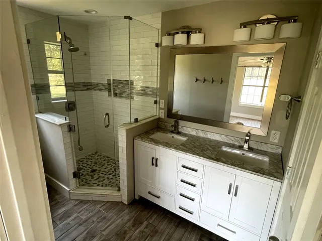 a bathroom with double sink and a mirror