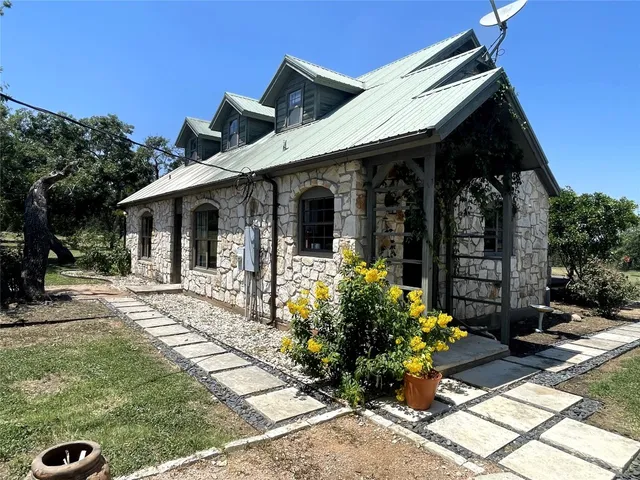 a view of a house with backyard porch and sitting area