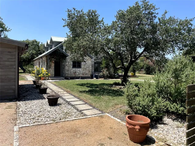 a view of a house with backyard porch and sitting area