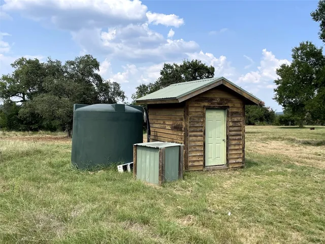 a kitchen with a refrigerator a sink cabinets and wooden floor