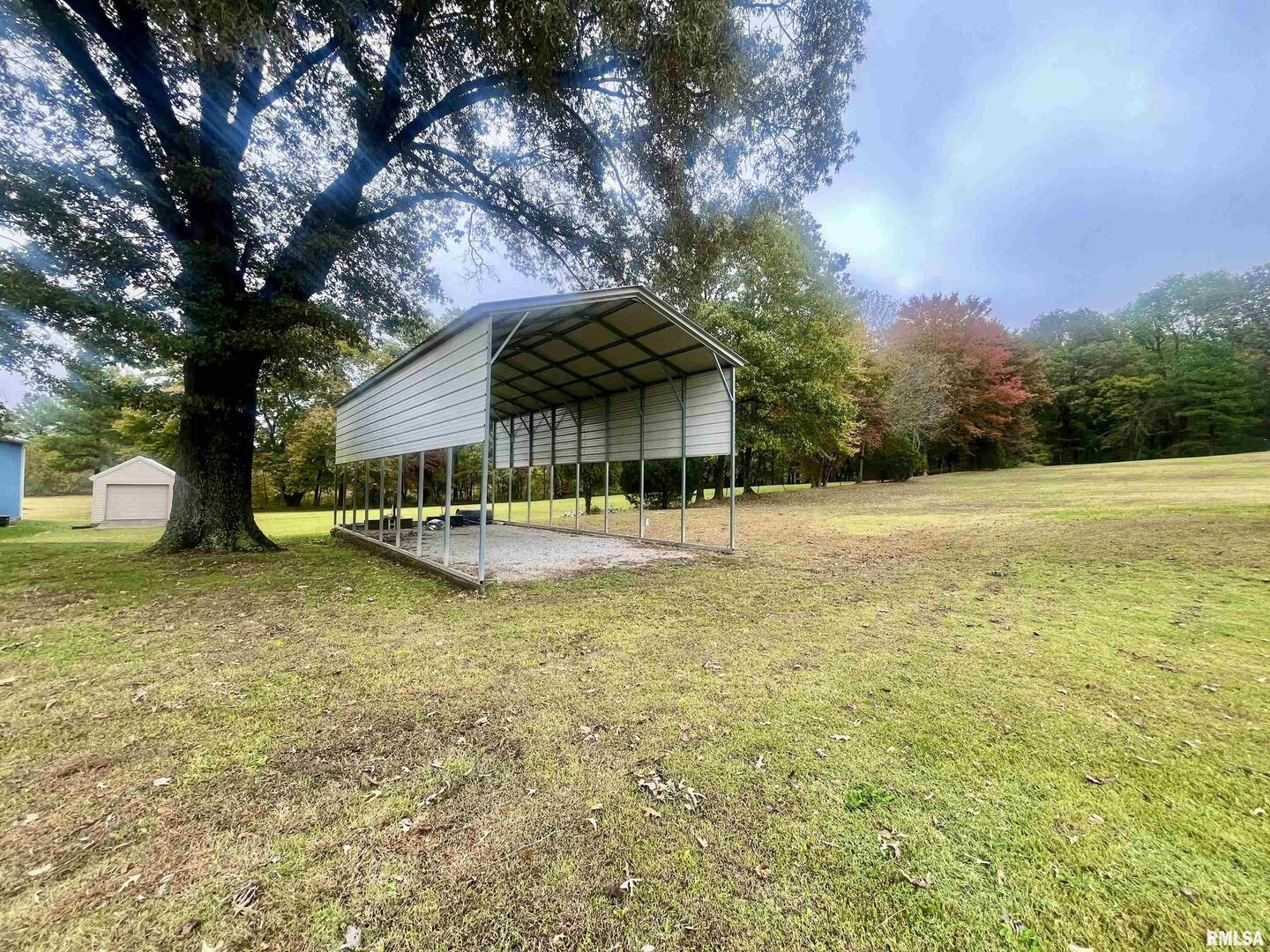 3220 Massac Creek Road Metropolis, IL 62960 - Photo 11 of 76 a view of a swimming pool with an outdoor space and seating area