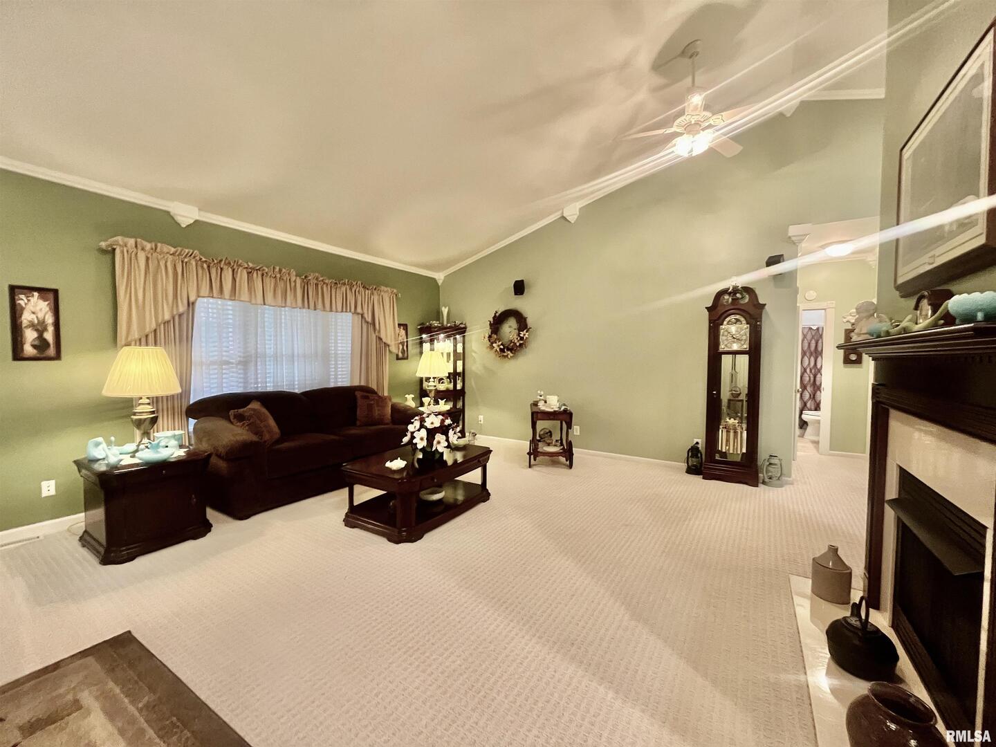 3220 Massac Creek Road Metropolis, IL 62960 - Photo 13 of 76 a living room with furniture a flat screen tv and a fireplace