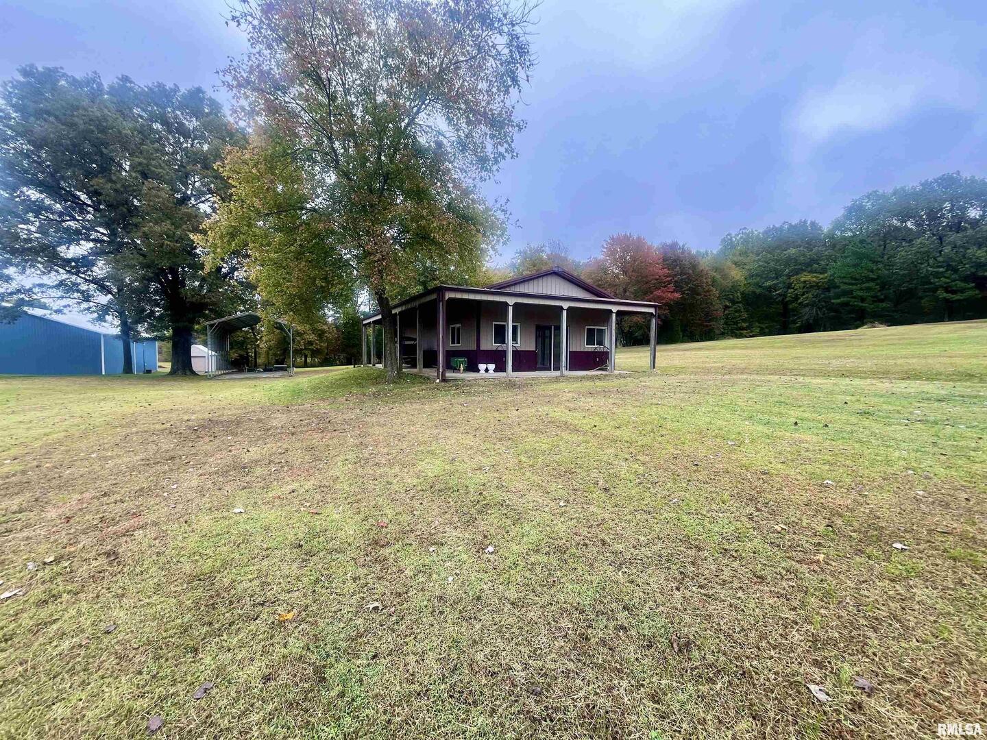 3220 Massac Creek Road Metropolis, IL 62960 - Photo 63 of 76 a view of a house with a big yard and large trees