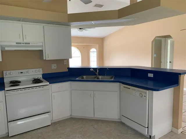 a kitchen with a sink and cabinets