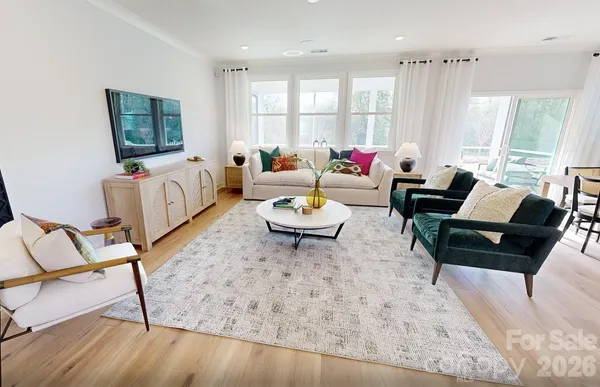 a living room with furniture and a book shelf