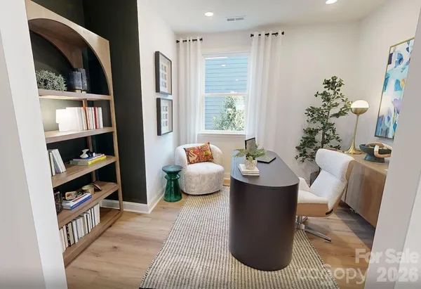 a living room with furniture kitchen view and a large window
